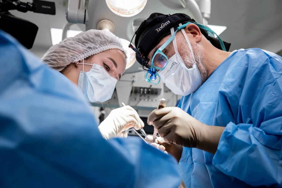 A surgeon performs rhinoplasty in the operating room