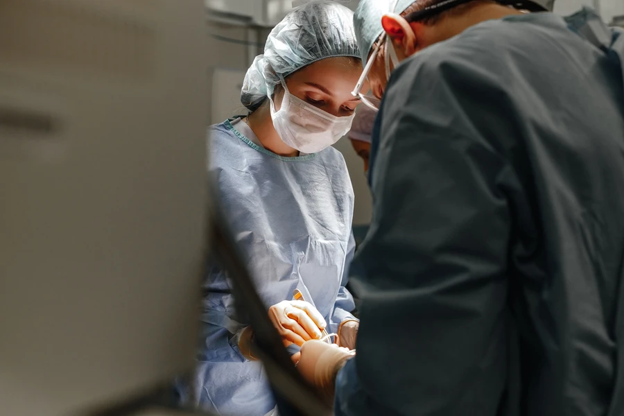 A clinic surgeon during nose surgery