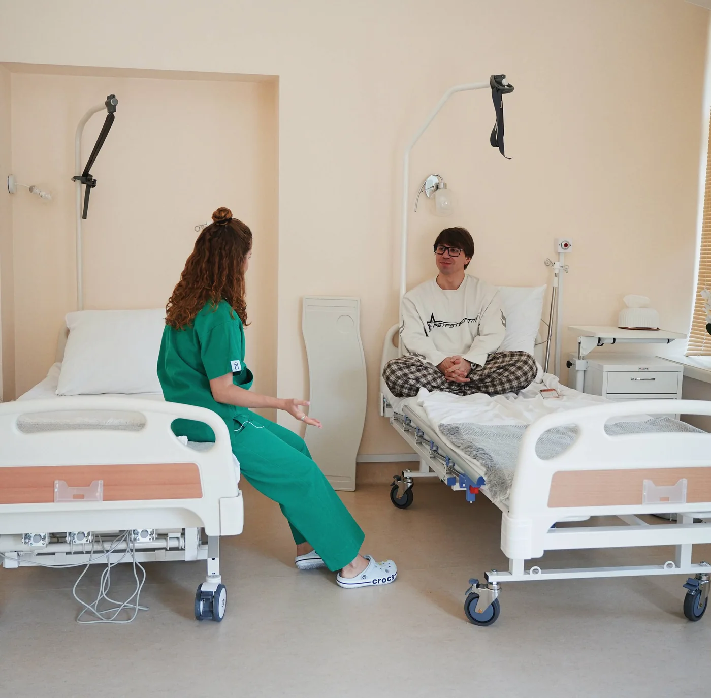 A patient and a nurse in a clinic ward after rhinoplasty